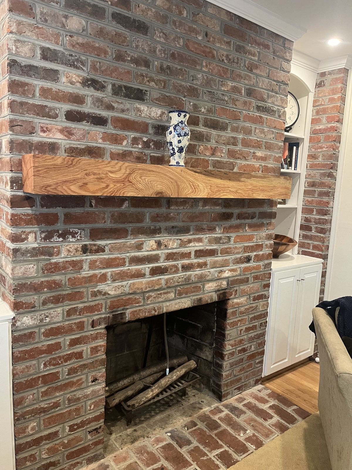 White oak floating mantel on brick fireplace