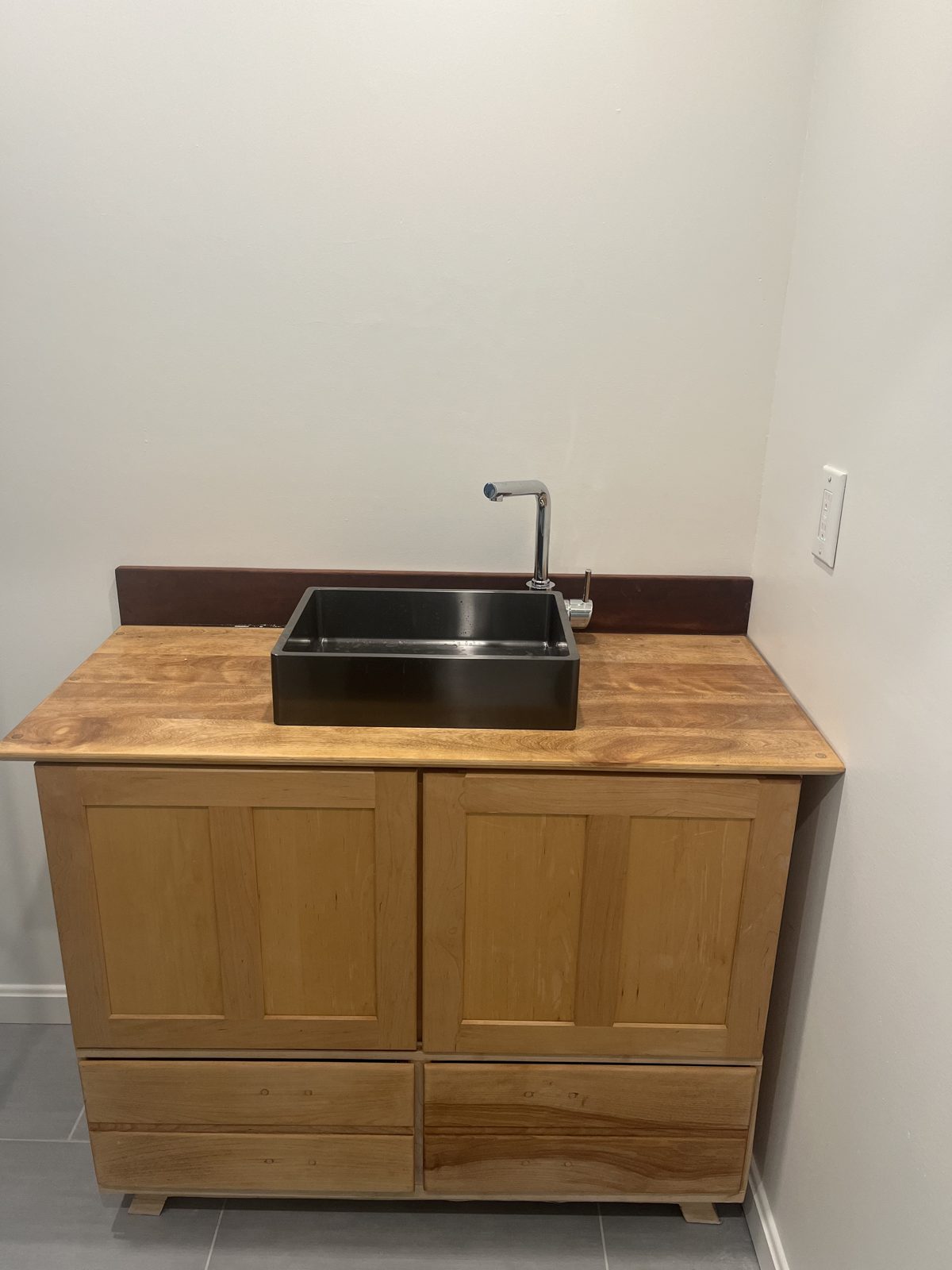 Maple bathroom vanity with farmhouse sink